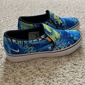 Nike slip on’s in multicolor tropical pattern.